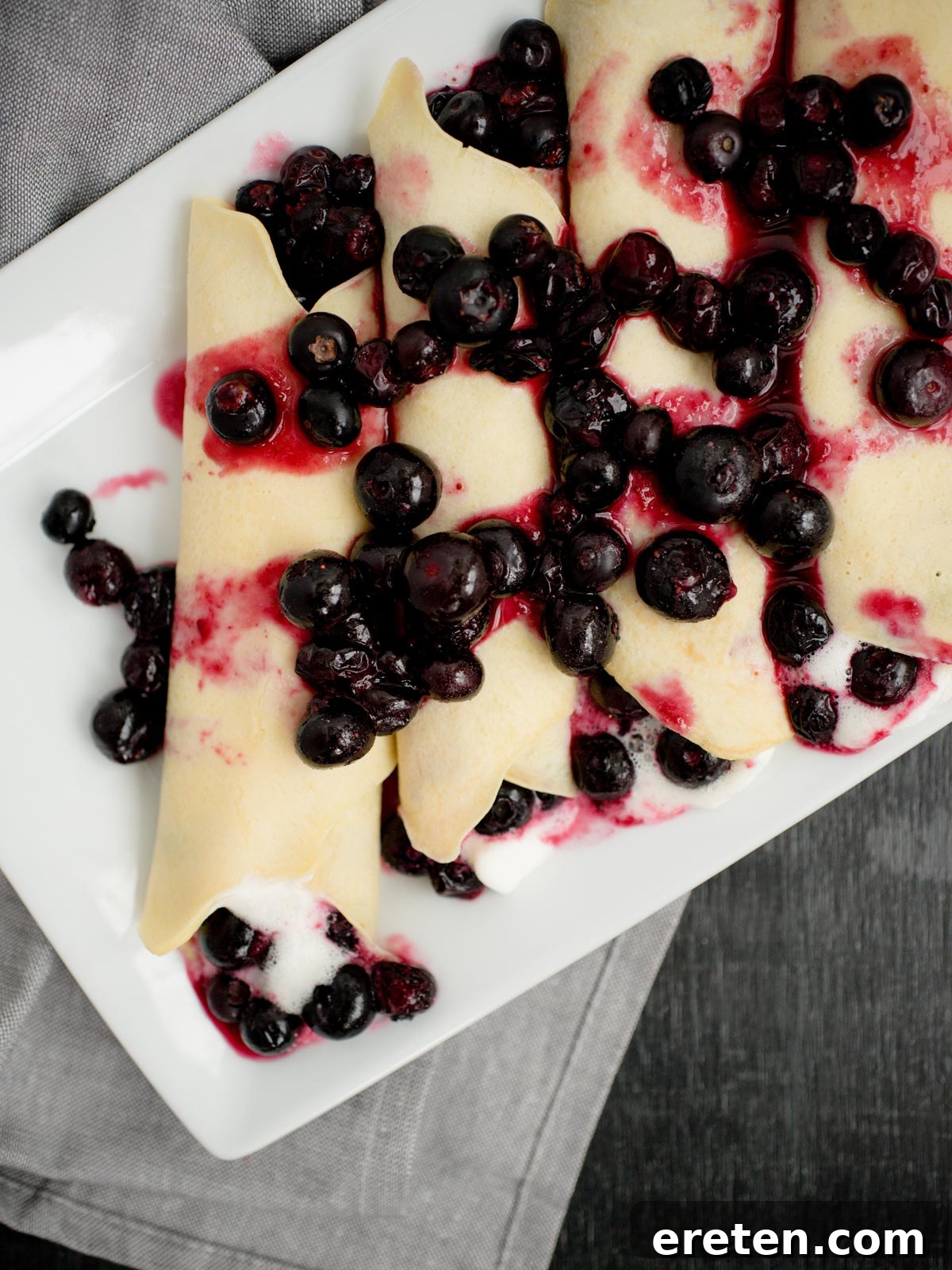 A perfectly cooked crepe folded and ready to be filled with various sweet or savory ingredients.