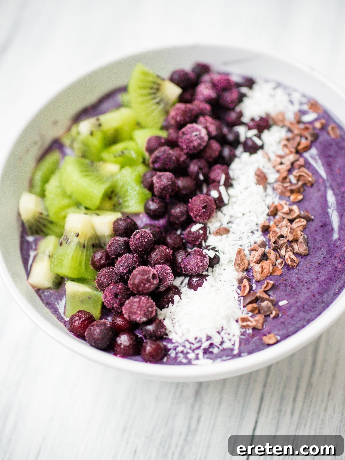 A top-down view of a ready-to-eat blueberry banana smoothie bowl, showing the beautiful arrangement of fresh toppings.