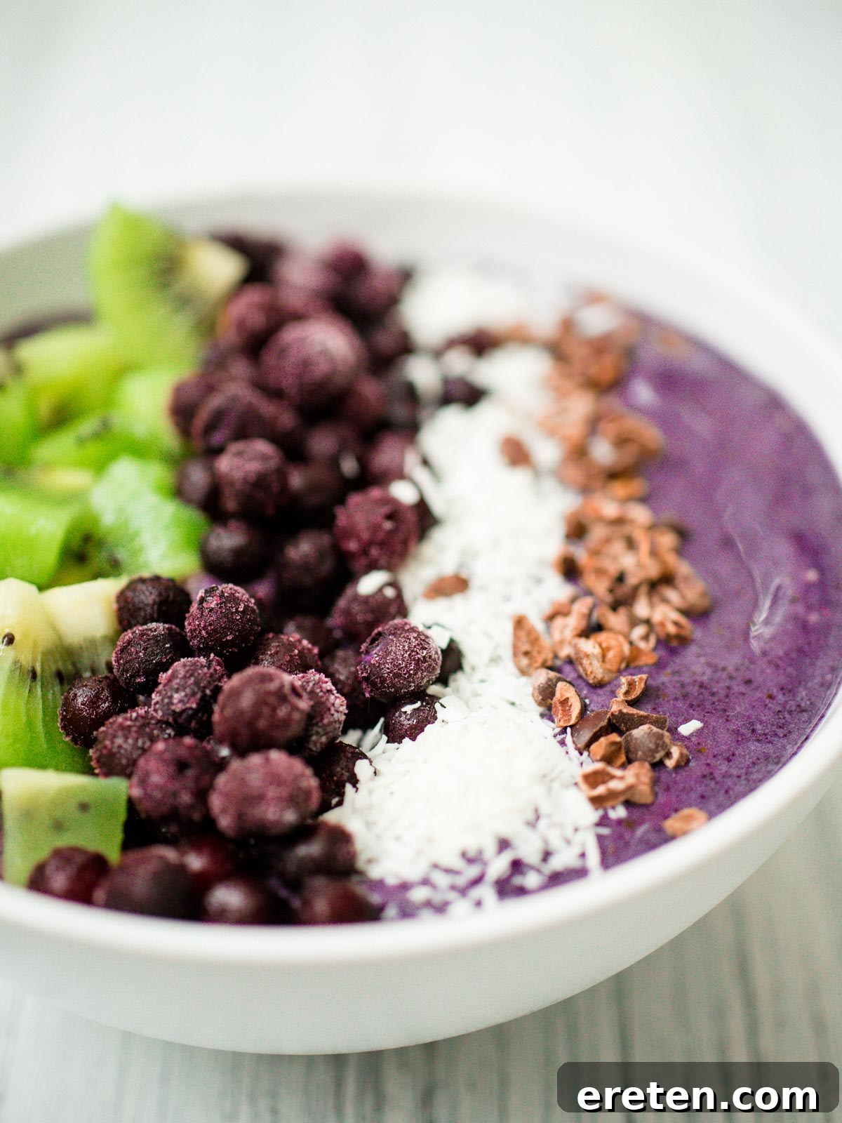 An overhead shot of a delightful blueberry banana smoothie bowl, garnished with a variety of colorful and healthy toppings.