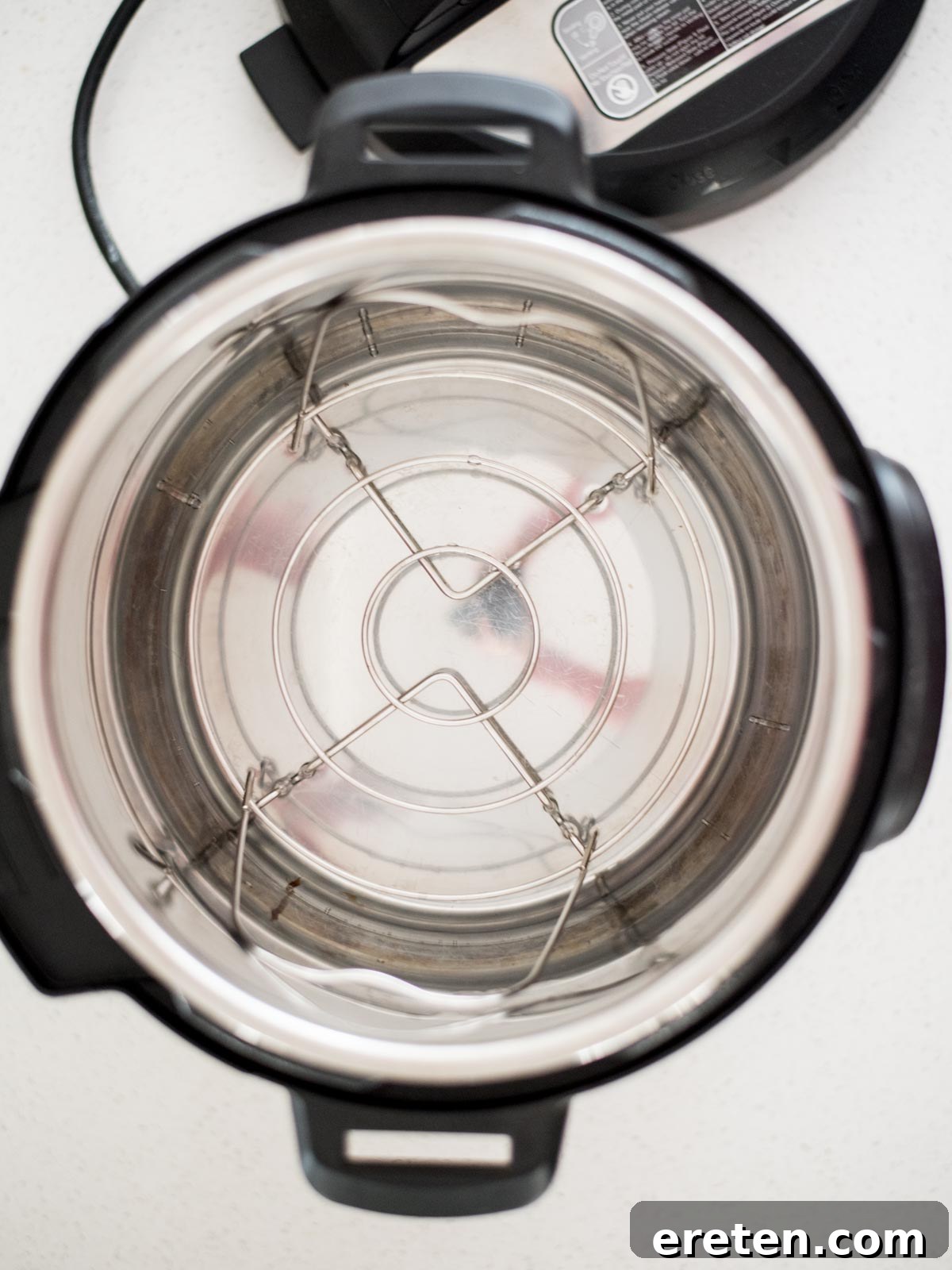 Foolproof Hard Boiled Eggs in Instant Pot 4 Trivet and water in the inner pot of an Instant Pot, ready for eggs.