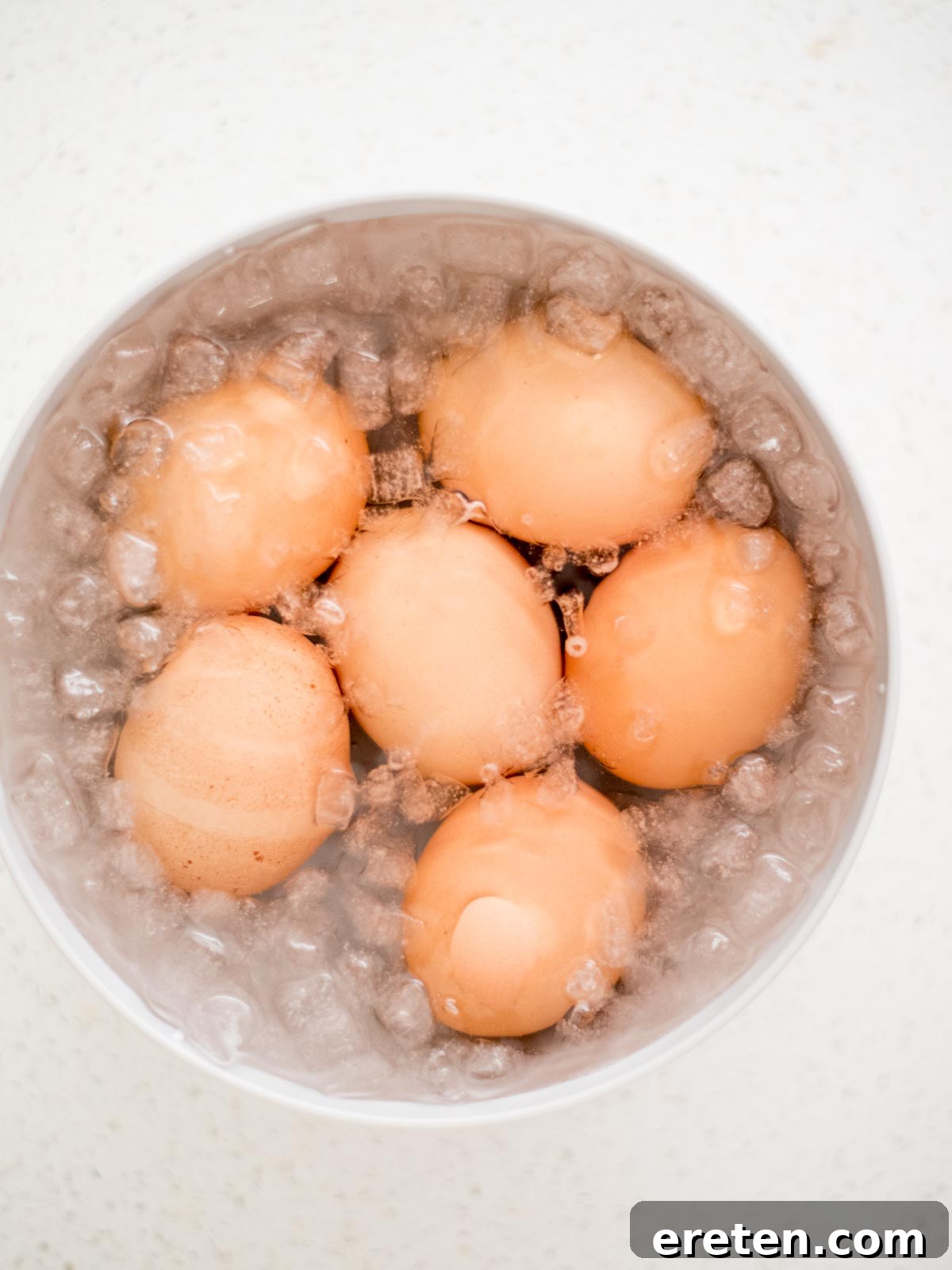 Foolproof Hard Boiled Eggs in Instant Pot 7 Cooked hard-boiled eggs submerged in an ice bath, a crucial step for easy peeling.