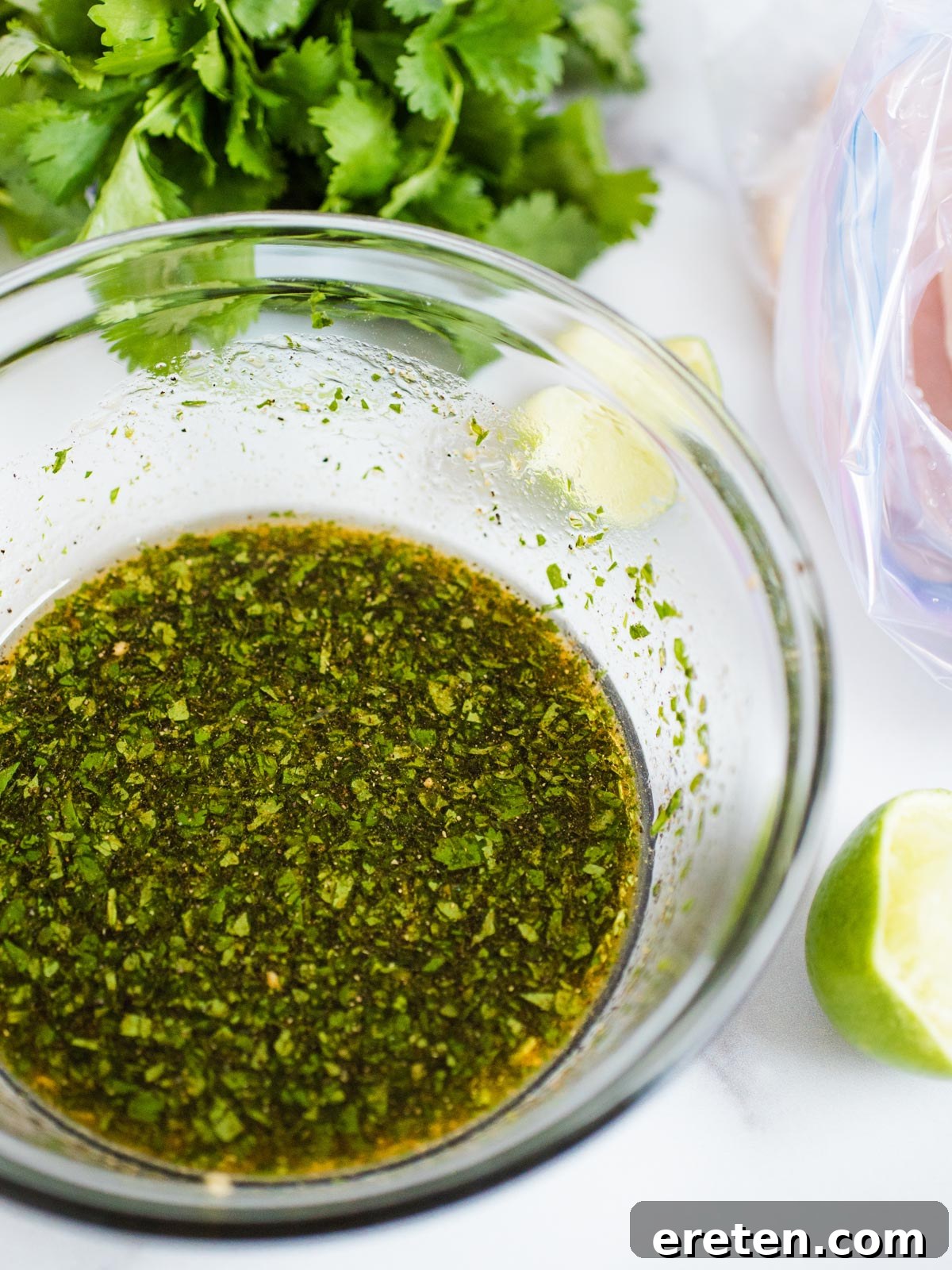 A bowl of freshly mixed honey lime marinade, showcasing its vibrant color.