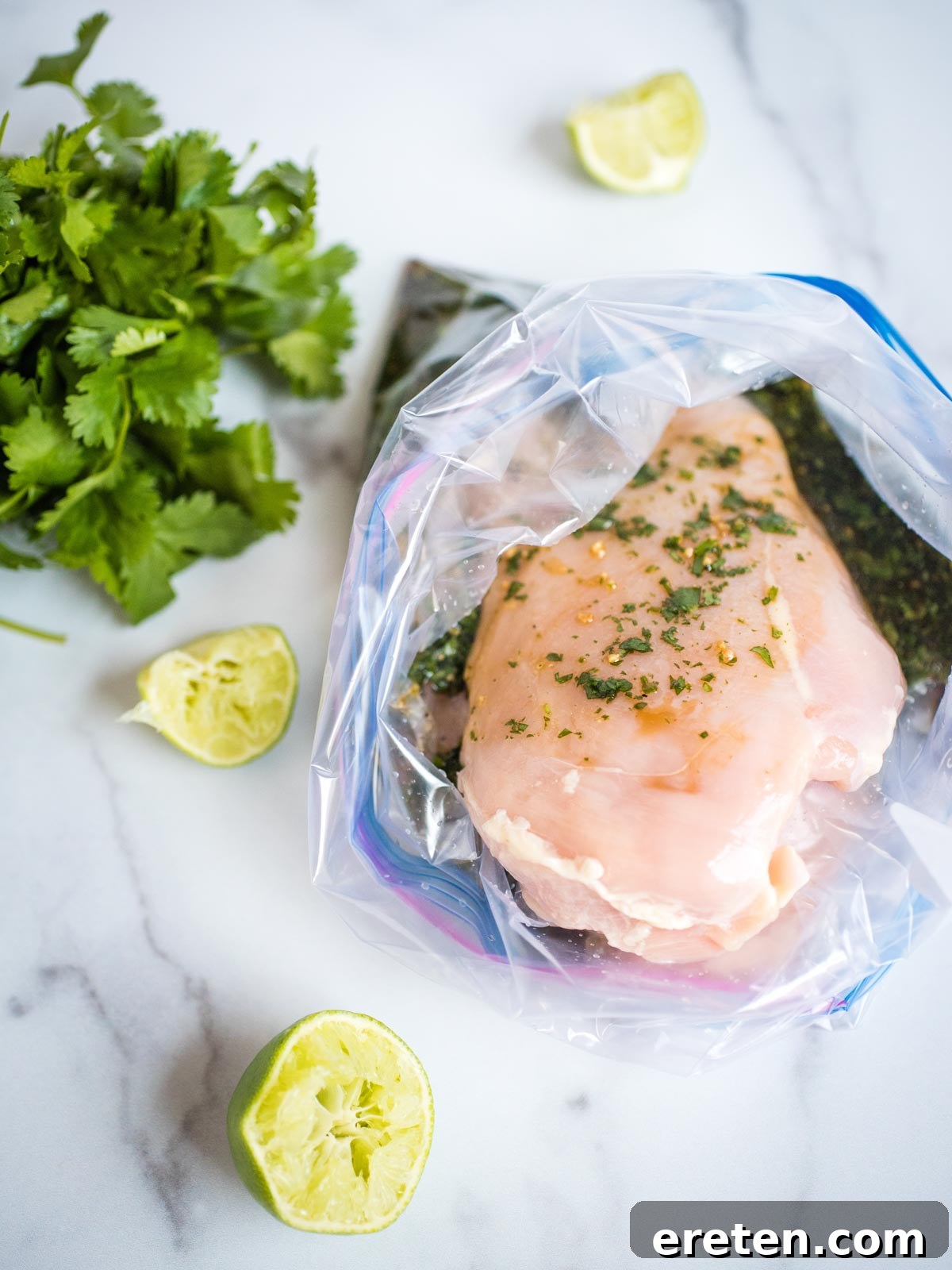 Marinating chicken breasts sealed in a ziploc bag, ready for refrigeration.