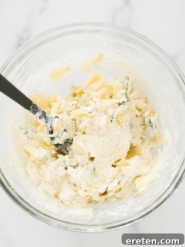 Spicy Artichoke Jalapeno Fusion 11 The entire Jalapeno Artichoke Dip mixture in a baking dish, unbaked and ready for the oven.