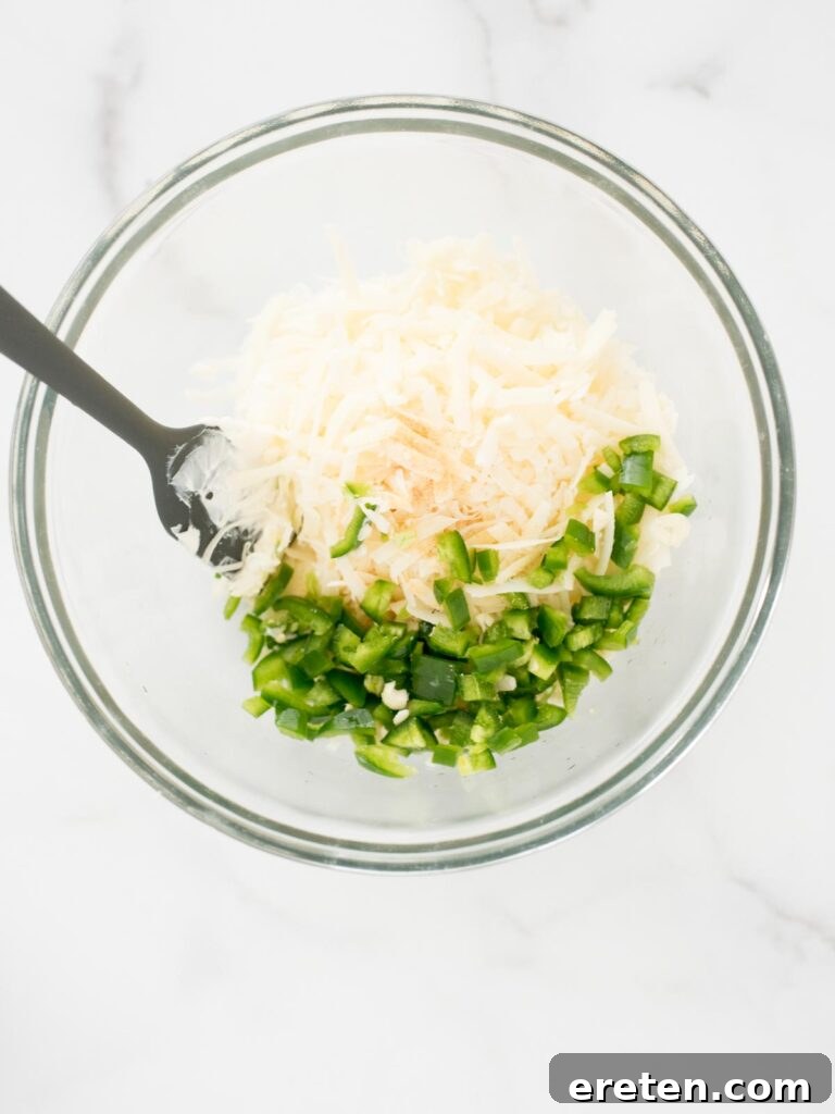Spicy Artichoke Jalapeno Fusion 8 Minced garlic cloves and diced jalapeño added to the bowl with other ingredients.
