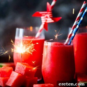 watermelon slush in glasses with paper straws and frozen watermelon chunks. Sparkler in watermelon
