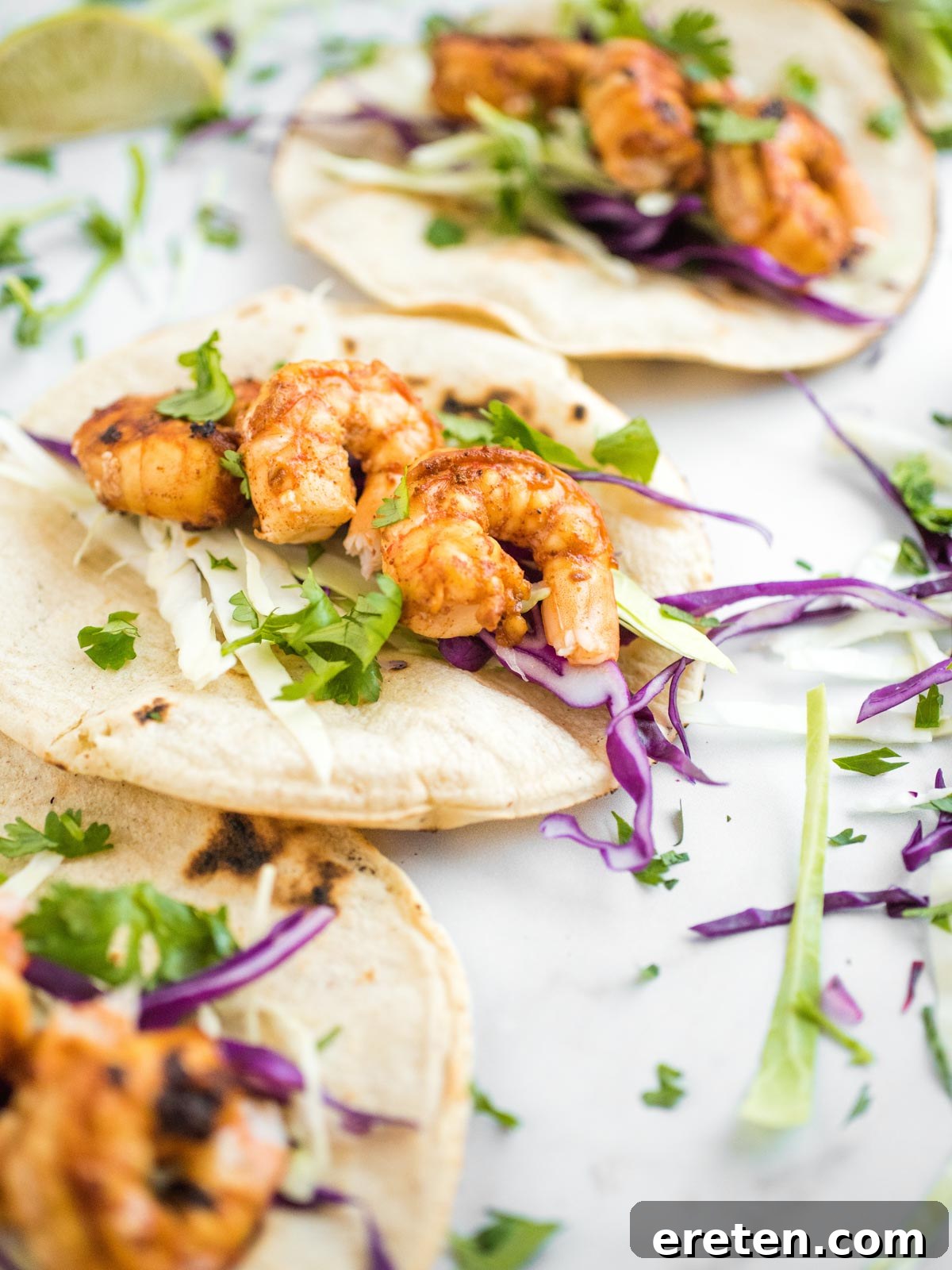 Shot of a chili lime shrimp taco opened up, showing the fillings