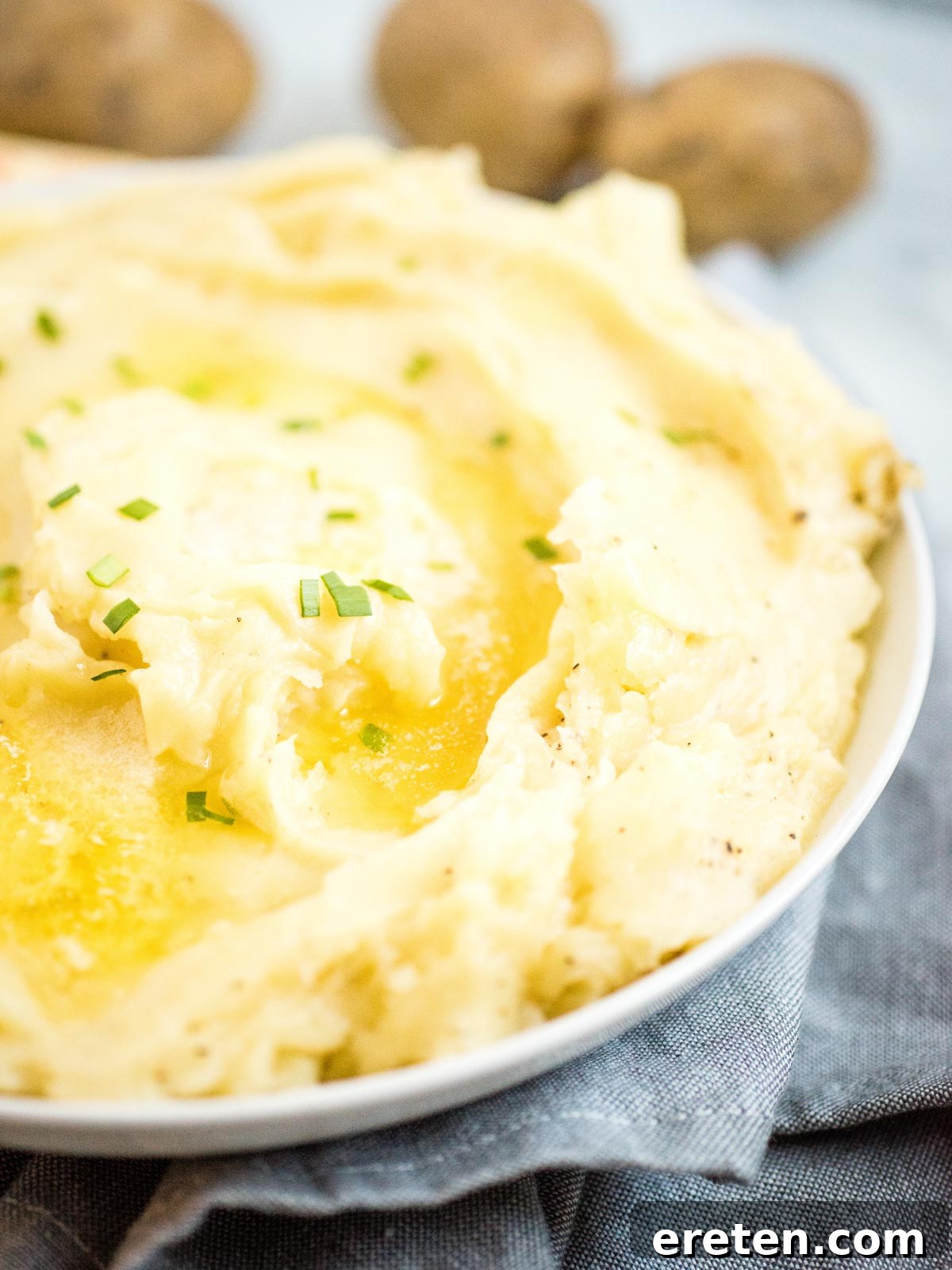 Creamy Instant Pot Mashed Potatoes topped with melted butter