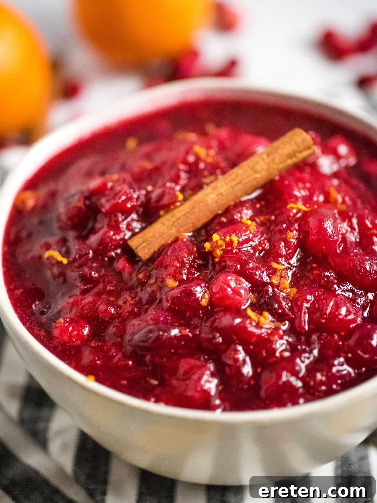 Vibrant Instant Pot Cranberry Orange Sauce 2 bowl full of cranberry sauce topped with a cinnamon stick