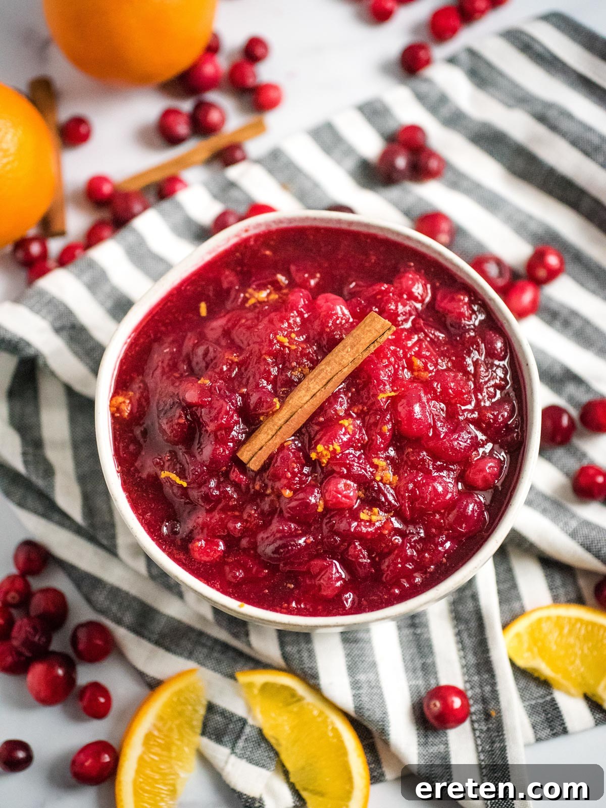 Vibrant Instant Pot Cranberry Orange Sauce 6 bowl of instant pot orange cranberry sauce surrounded by orange slices and cranberries