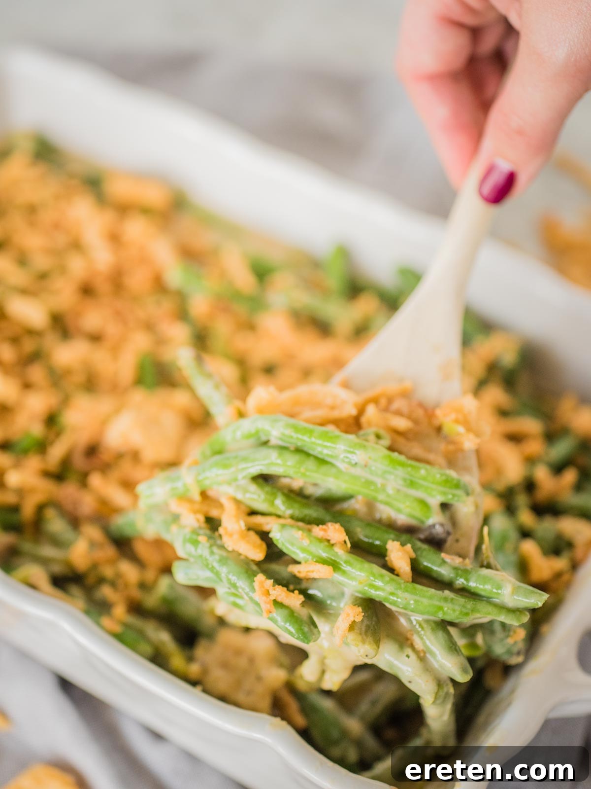 Ultimate Instant Pot Green Bean Casserole 2 green bean casserole being scooped out of casserole dish