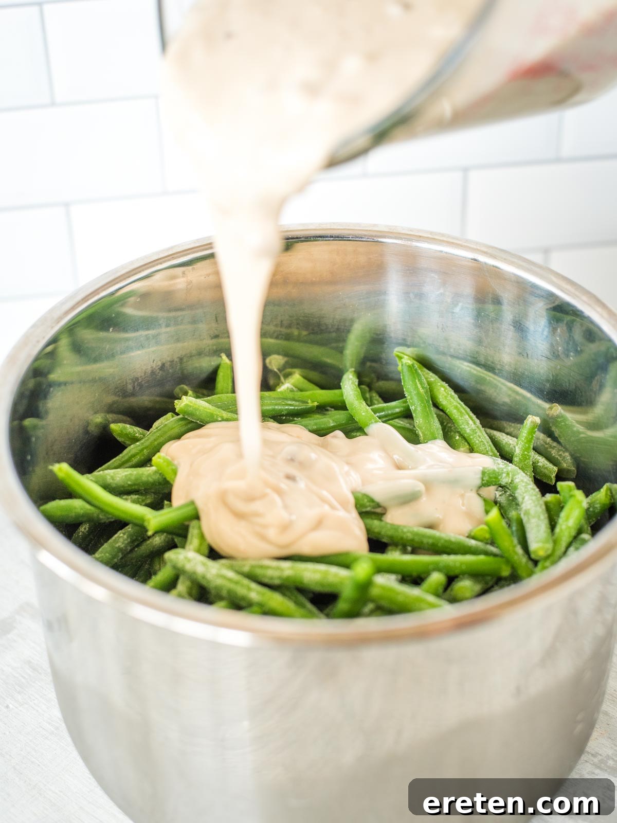 Ultimate Instant Pot Green Bean Casserole 5 green bean casserole mix being poured into instant pot sleeve