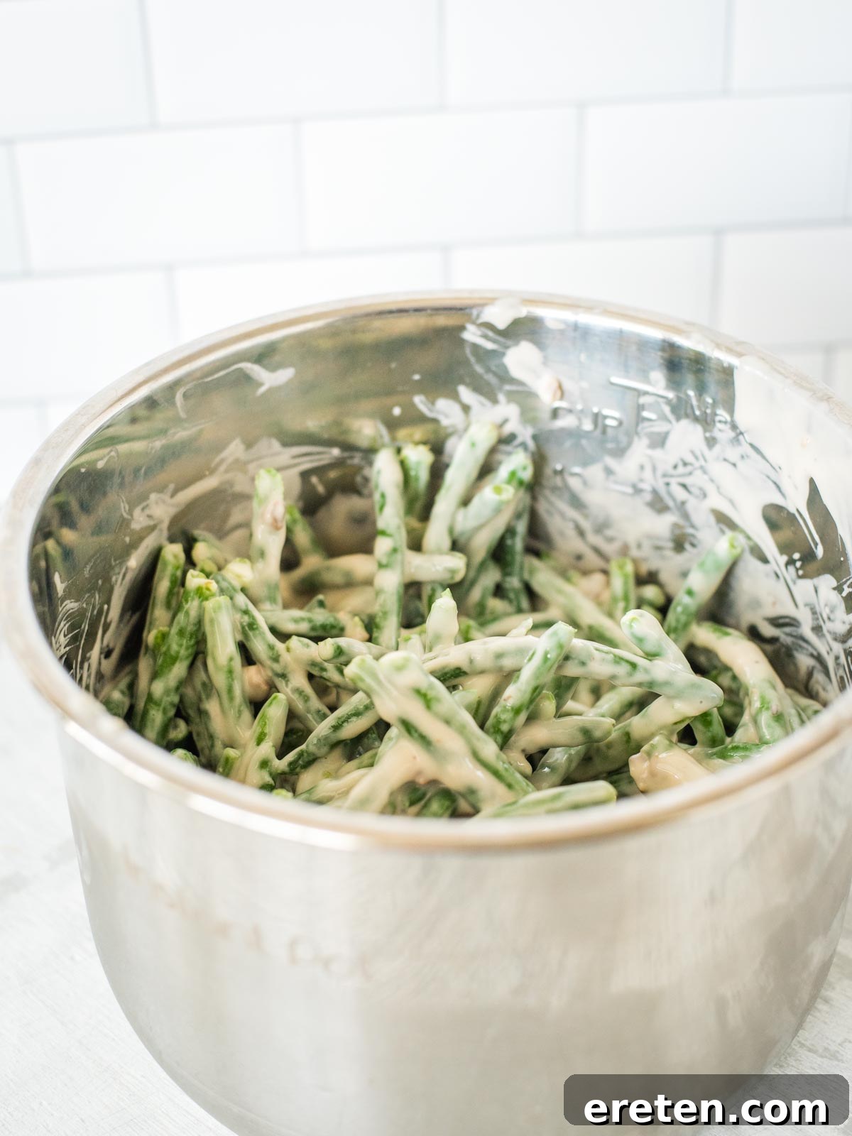 Ultimate Instant Pot Green Bean Casserole 6 green bean casserole ingredients mixed together in instant pot sleeve
