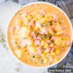 white bowl of creamy ham and potato corn chowder