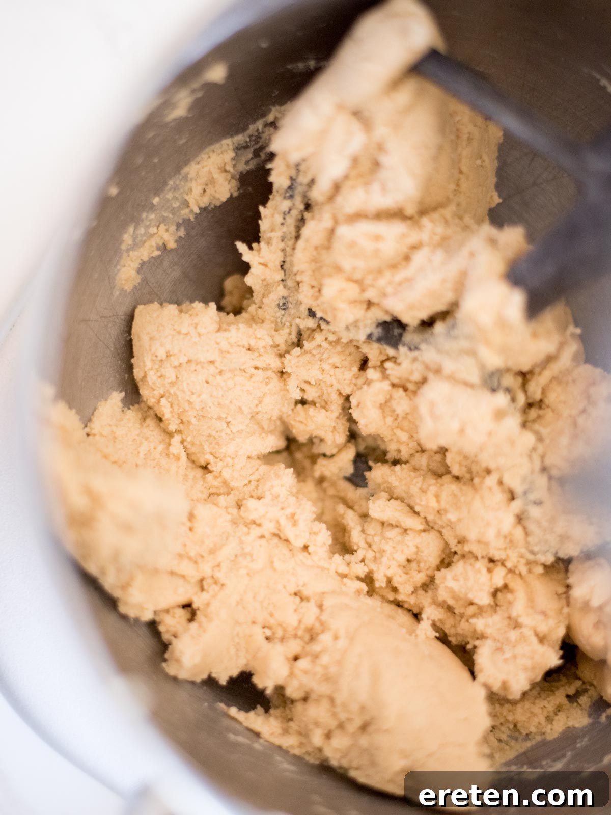 Smooth, well-combined cookie dough without chocolate chips in a mixing bowl, ready for the next step