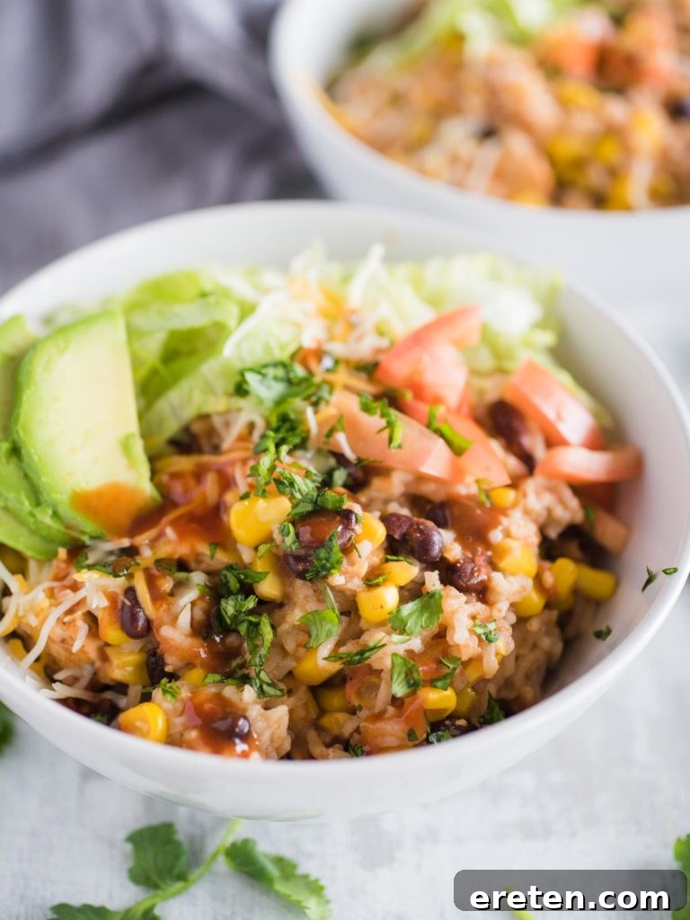 up close shot of instant pot chicken burrito bowl with toppings