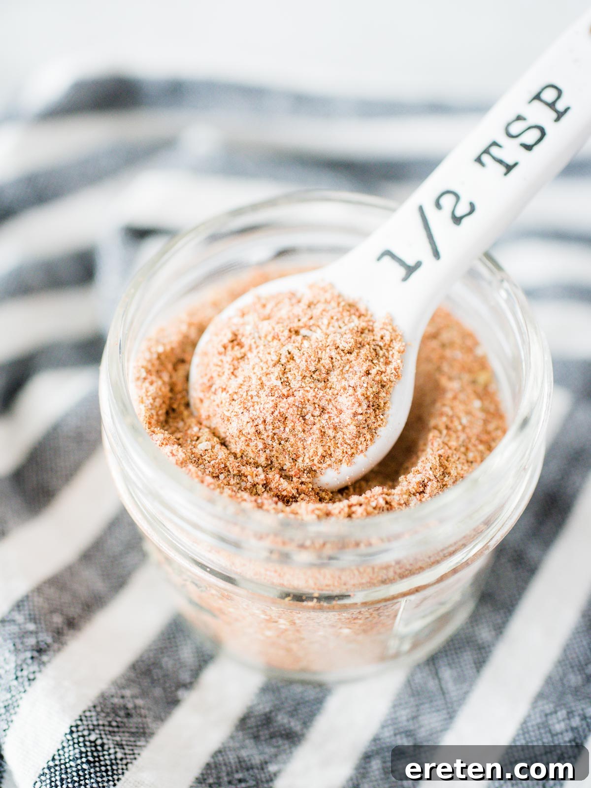 Homemade Mild Taco Spice Blend 2 Homemade taco seasoning in a glass jar with a small measuring spoon, ready for use.