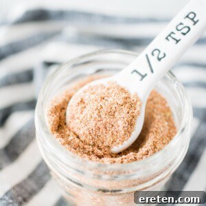 Homemade taco seasoning in a jar with a measuring spoon