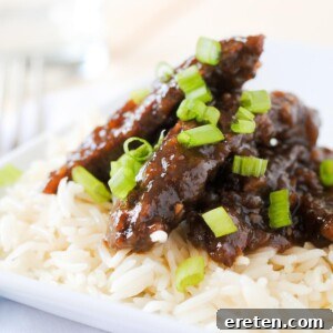 Sweet and Savory Teriyaki Beef with Rice 5 beef teriyaki on white rice on a white plate