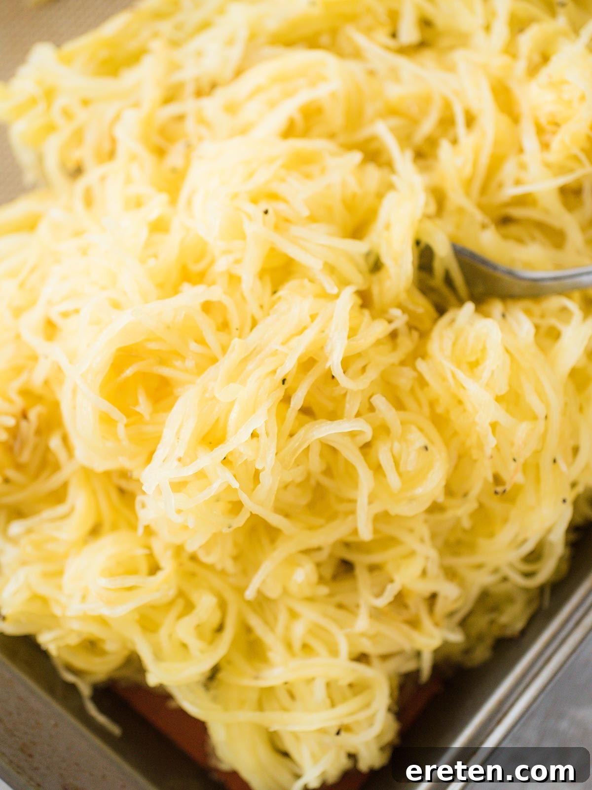 Perfect Oven Roasted Spaghetti Squash 4 roasted spaghetti squash rings cooling on a baking sheet before peeling