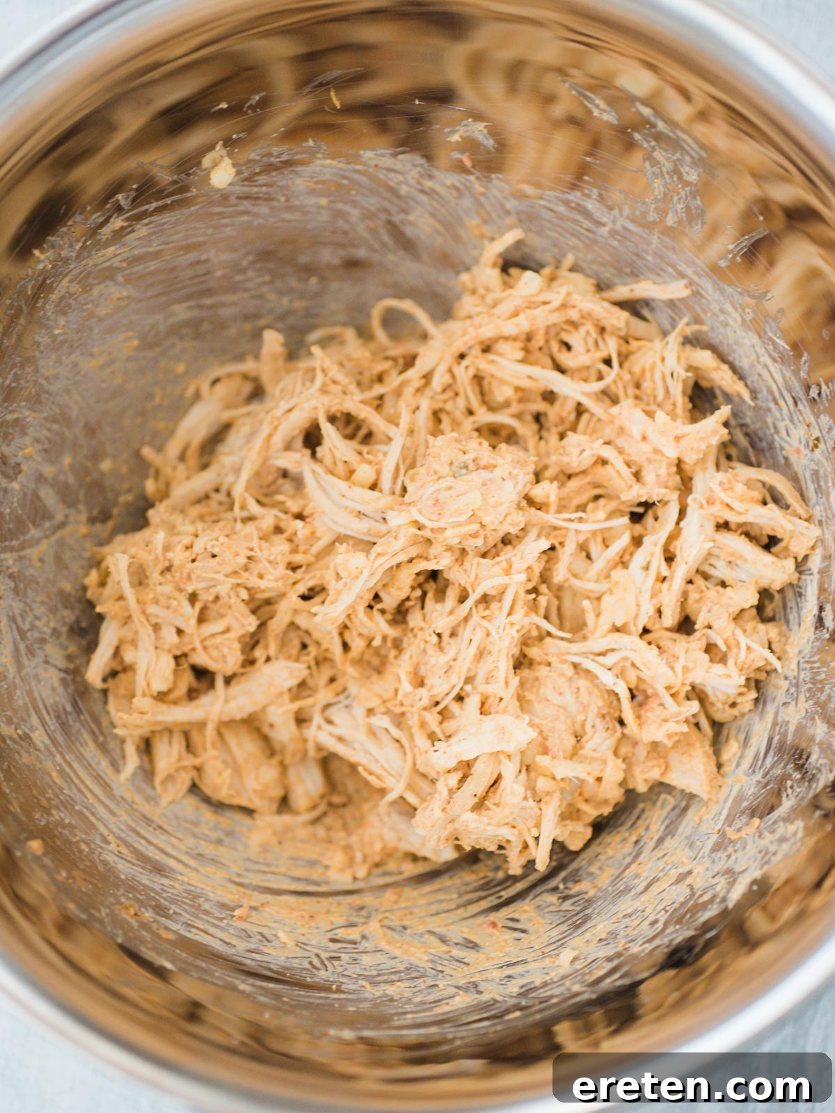 Crispy Creamy Chicken Taquitos 4 A bowl brimming with the savory, creamy shredded chicken and pepper jack cheese mixture, perfectly seasoned and ready to be scooped into corn tortillas for taquitos.