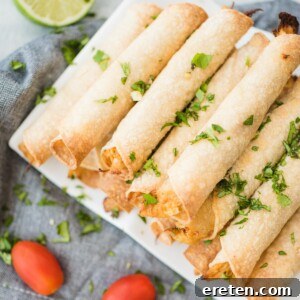 stack of chicken taquitos on a white plate