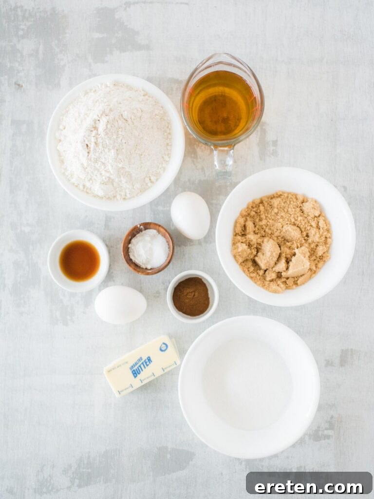 Caramel Apple Cinnamon Cupcakes 3 A collection of ingredients neatly arranged on a counter, including flour, sugars, butter, eggs, and a bottle of apple cider, ready for baking apple cider cupcakes.
