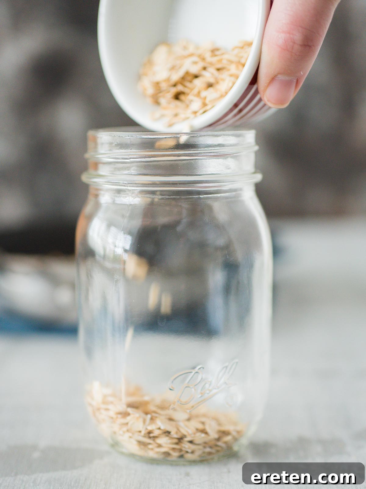 Oats being poured into a jar