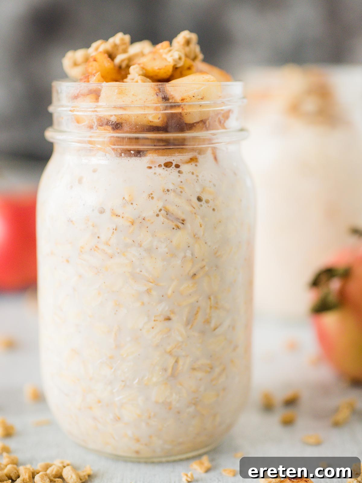 Jar of apple pie overnight oats topped with granola