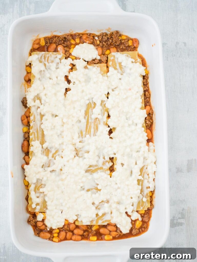 Kickin Tex Mex Lasagna 6 A creamy, spiced cottage cheese mixture spread over the first noodle layer of the Tex Mex lasagna.