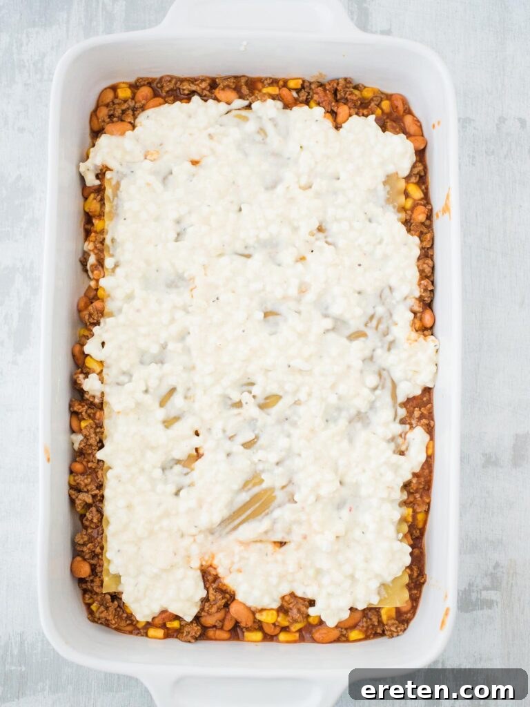 Kickin Tex Mex Lasagna 9 The second portion of the creamy cheese mixture spread over the noodles.