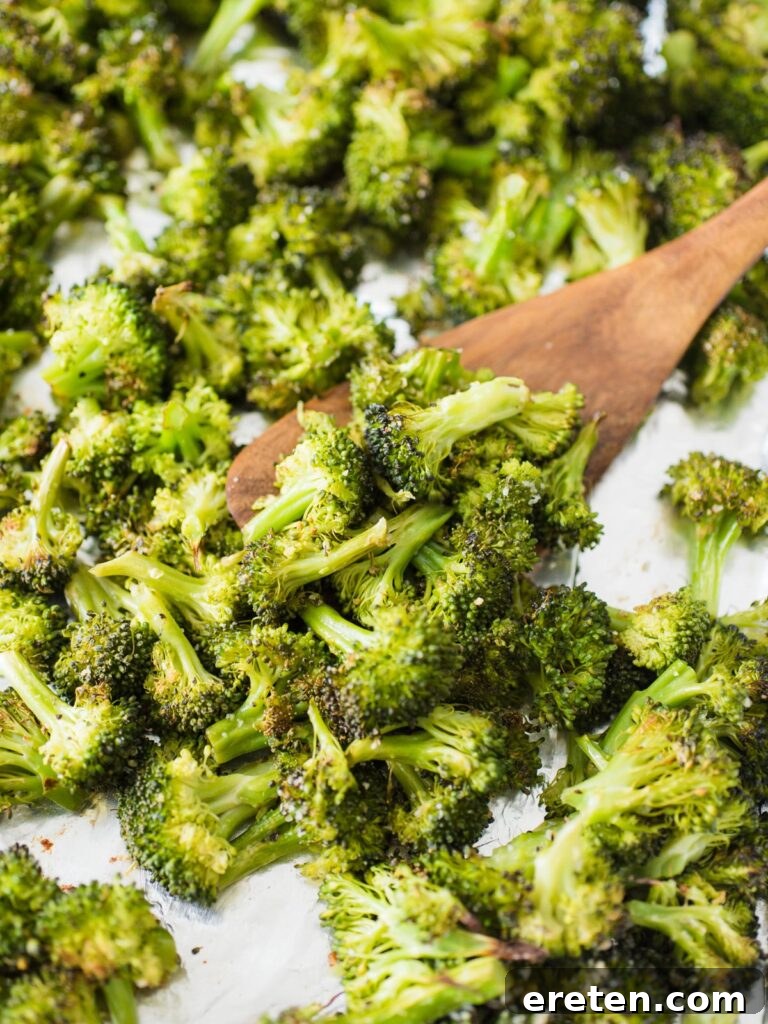 Crispy Oven Roasted Broccoli 4 Crispy roasted broccoli fresh out of the oven, piled on a baking sheet, ready to serve.
