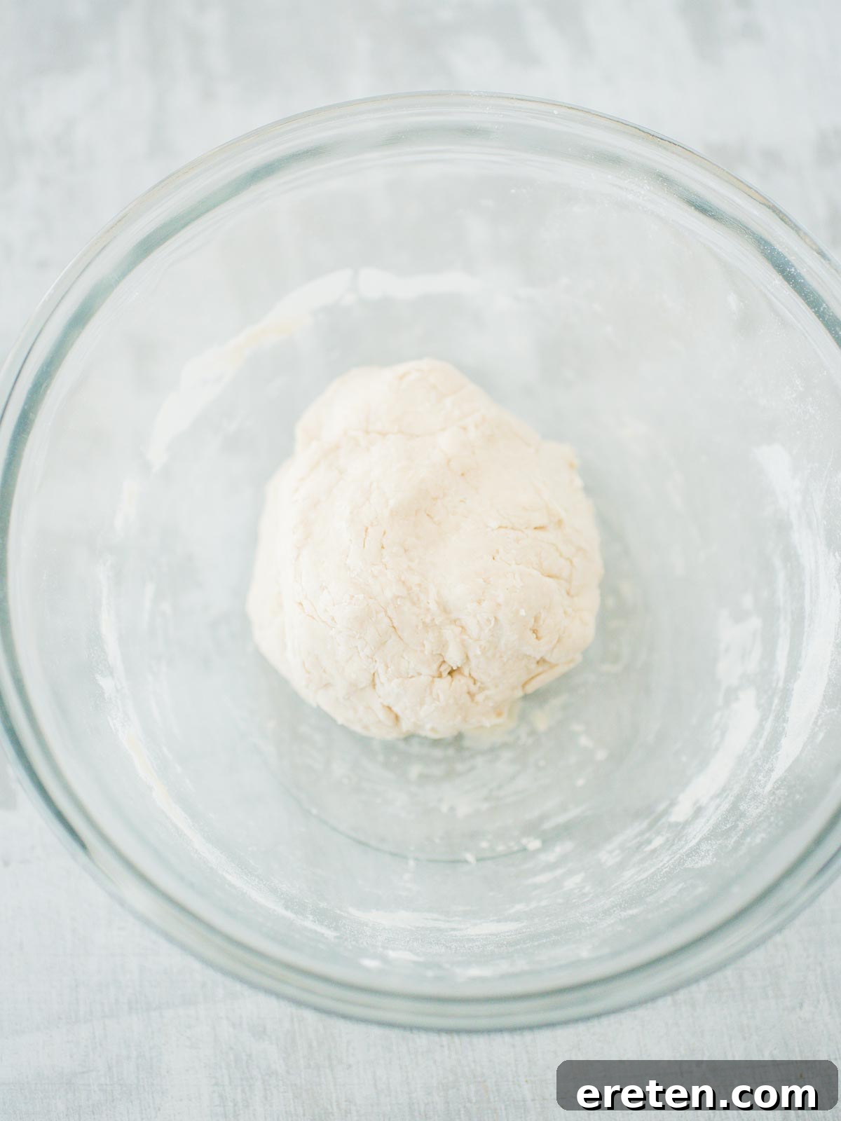 Sweet Pizza Creations: A Homemade Guide 3 Freshly prepared pizza dough resting in a bowl, ready to be rolled out for the pumpkin dessert pizza.