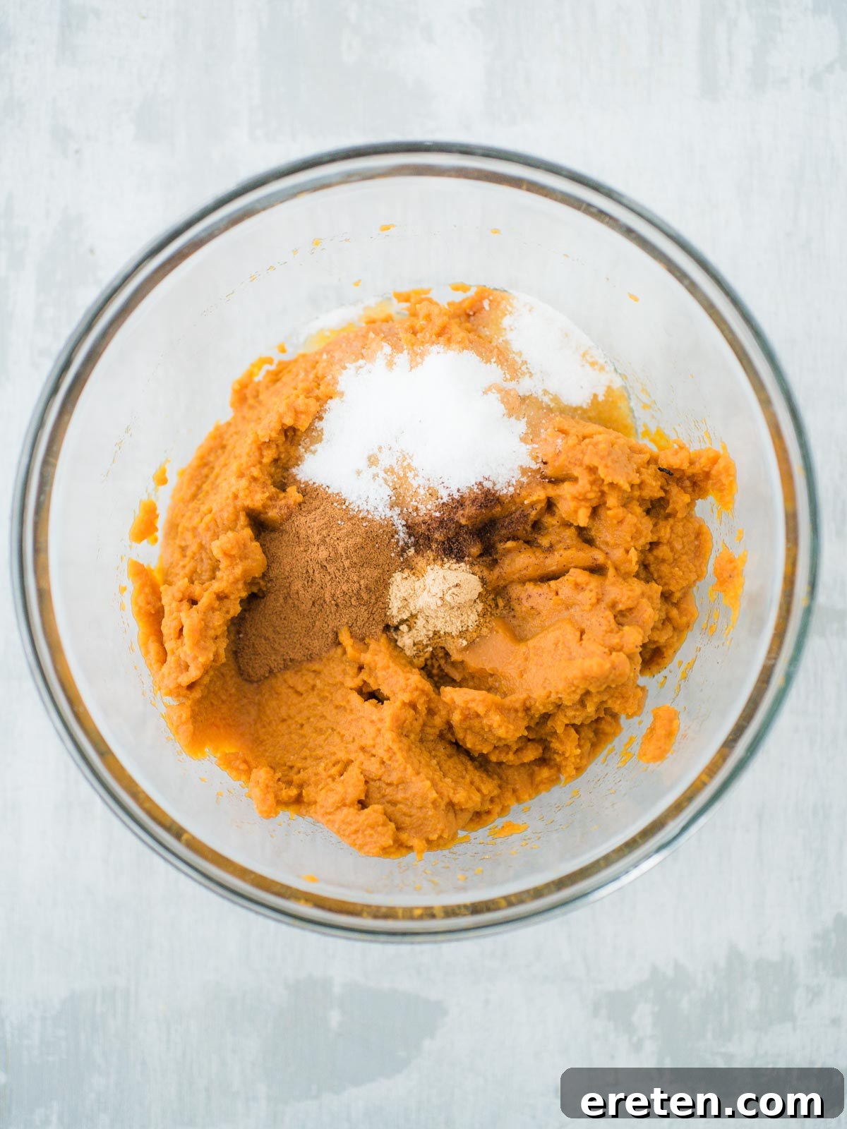 Sweet Pizza Creations: A Homemade Guide 4 A bowl filled with vibrant orange pumpkin puree and spices, ready to be mixed for the pumpkin spread.