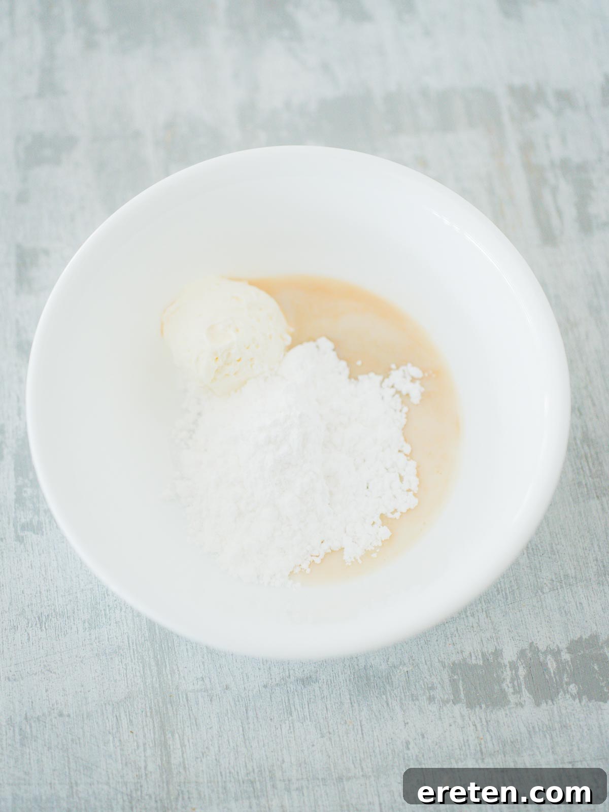 Sweet Pizza Creations: A Homemade Guide 6 The smooth, creamy ingredients for the cream cheese drizzle mixed in a small bowl.