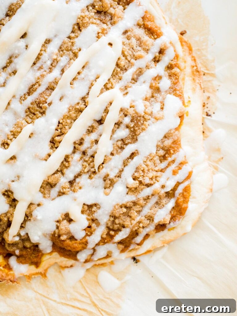 Sweet Pizza Creations: A Homemade Guide 8 A whole, unsliced Pumpkin Dessert Pizza, beautifully topped with streusel and cream cheese drizzle, ready to be enjoyed.