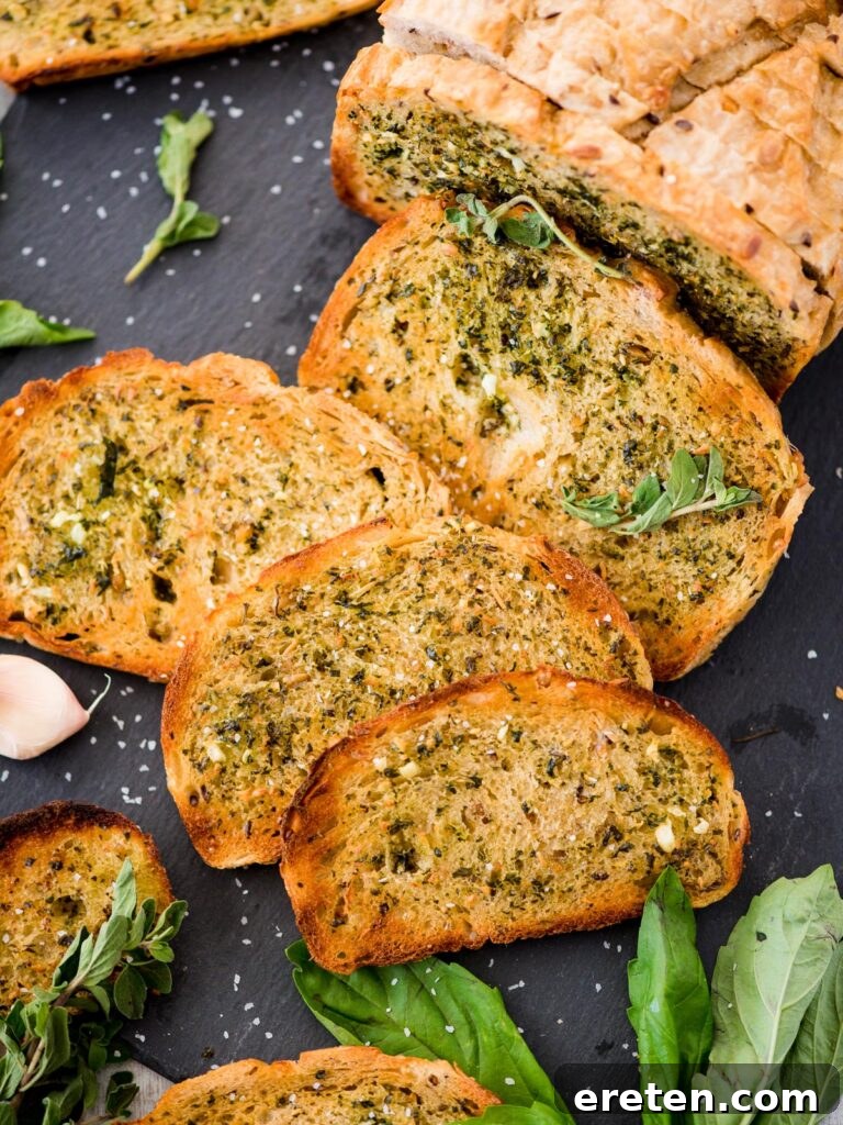 sliced easy garlic bread on board sprinkled with salt