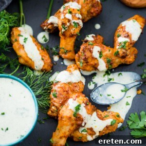 Crispy Air Fryer Dry Rub Wings 11 crispy chicken wings in the air fryer sprinkled with parsley and a ranch drizzle