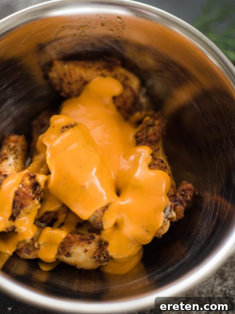 Crispy Air Fryer Dry Rub Wings 9 cooked air fried chicken wings with sauce drizzled on them