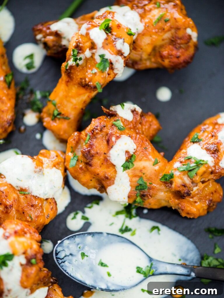 Crispy Air Fryer Dry Rub Wings 10 crispy chicken wings in the air fryer sprinkled with parsley and a ranch drizzle