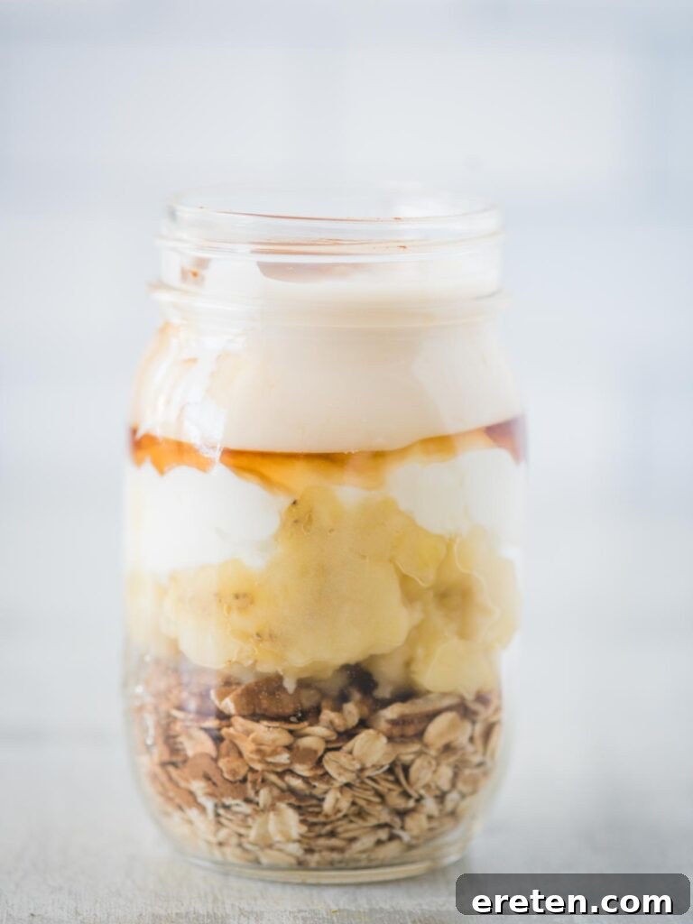 Creamy Banana Nut Bread Overnight Oats 11 Unsweetened plain almond milk poured over all the ingredients in the jar, providing the liquid base for the oats to soak overnight.