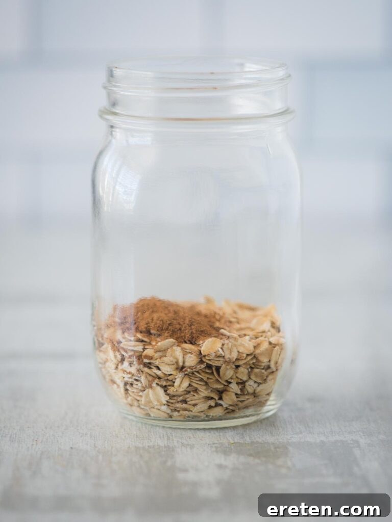 Creamy Banana Nut Bread Overnight Oats 5 Cinnamon and kosher salt being added to the jar of oats, introducing warm spice to the banana bread overnight oats.