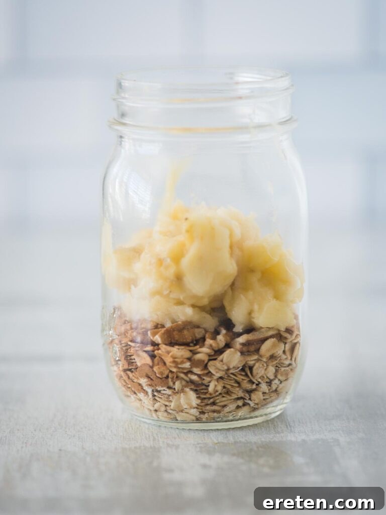 Creamy Banana Nut Bread Overnight Oats 7 Smooth, mashed ripe banana being added to the jar, providing natural sweetness and the core flavor for the overnight oats.