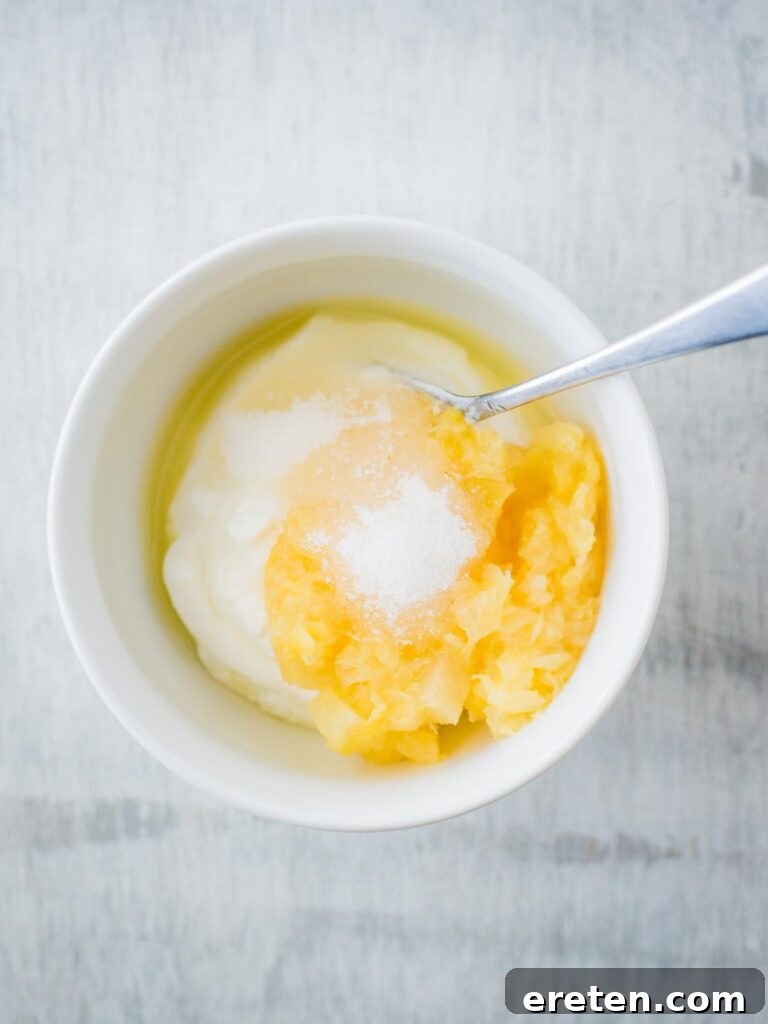 All ingredients for creamy pineapple dipping sauce in a bowl