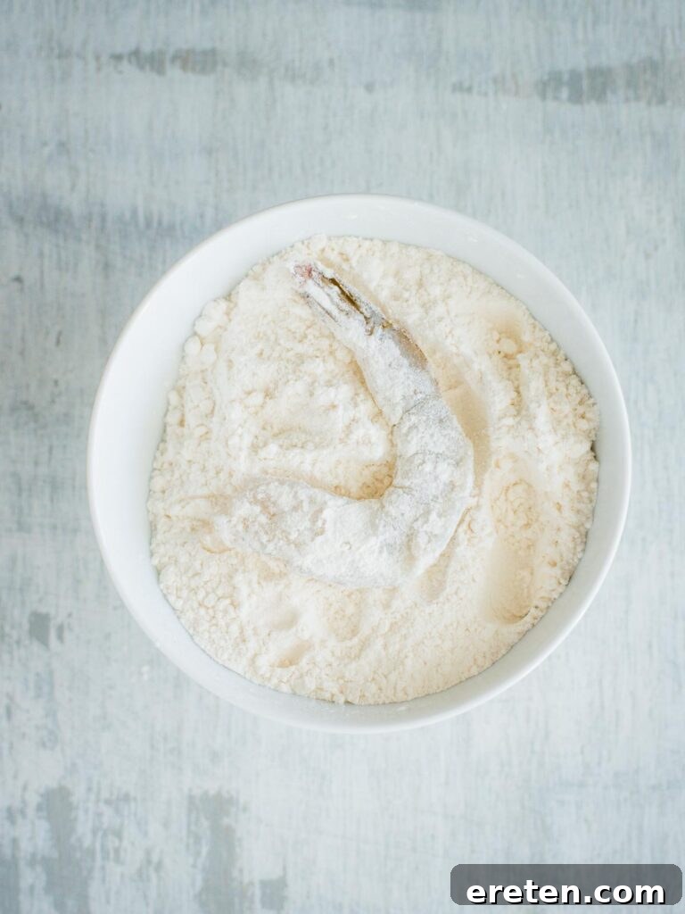 Shrimp being coated in flour