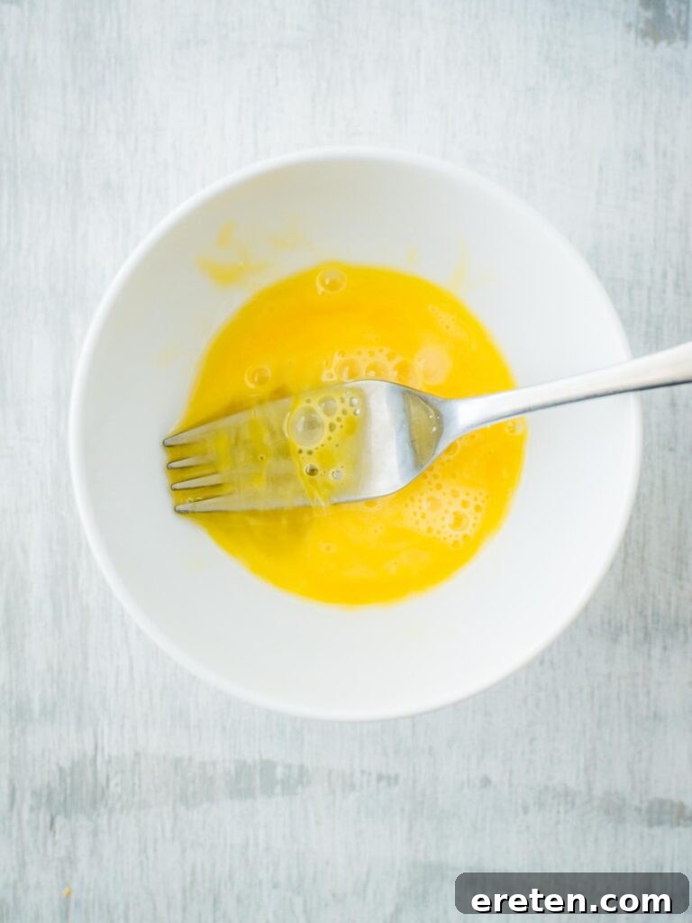 Whisked egg in a bowl for breading