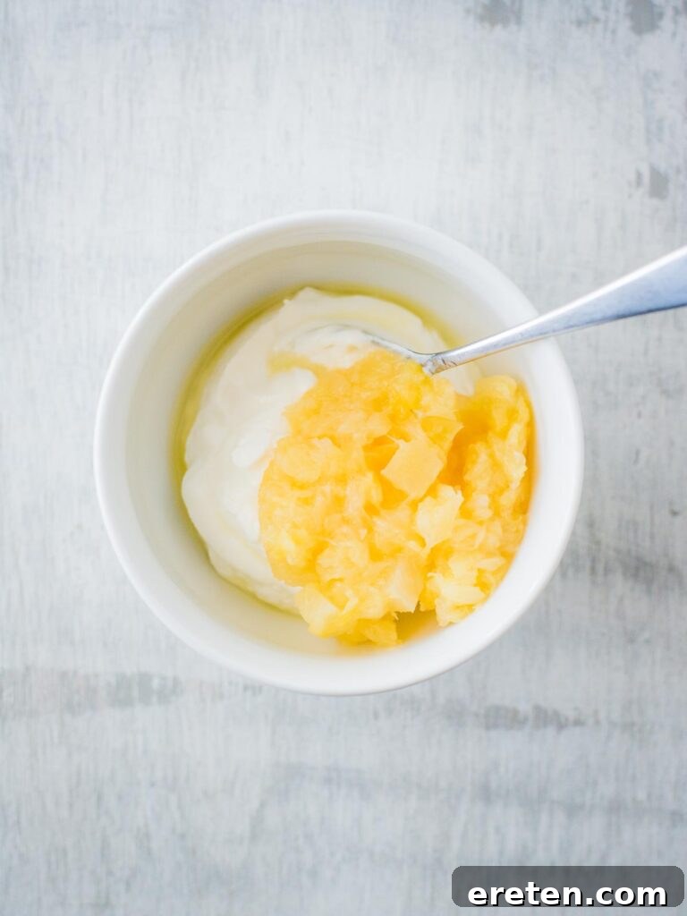 Pineapple and yogurt combined in a bowl