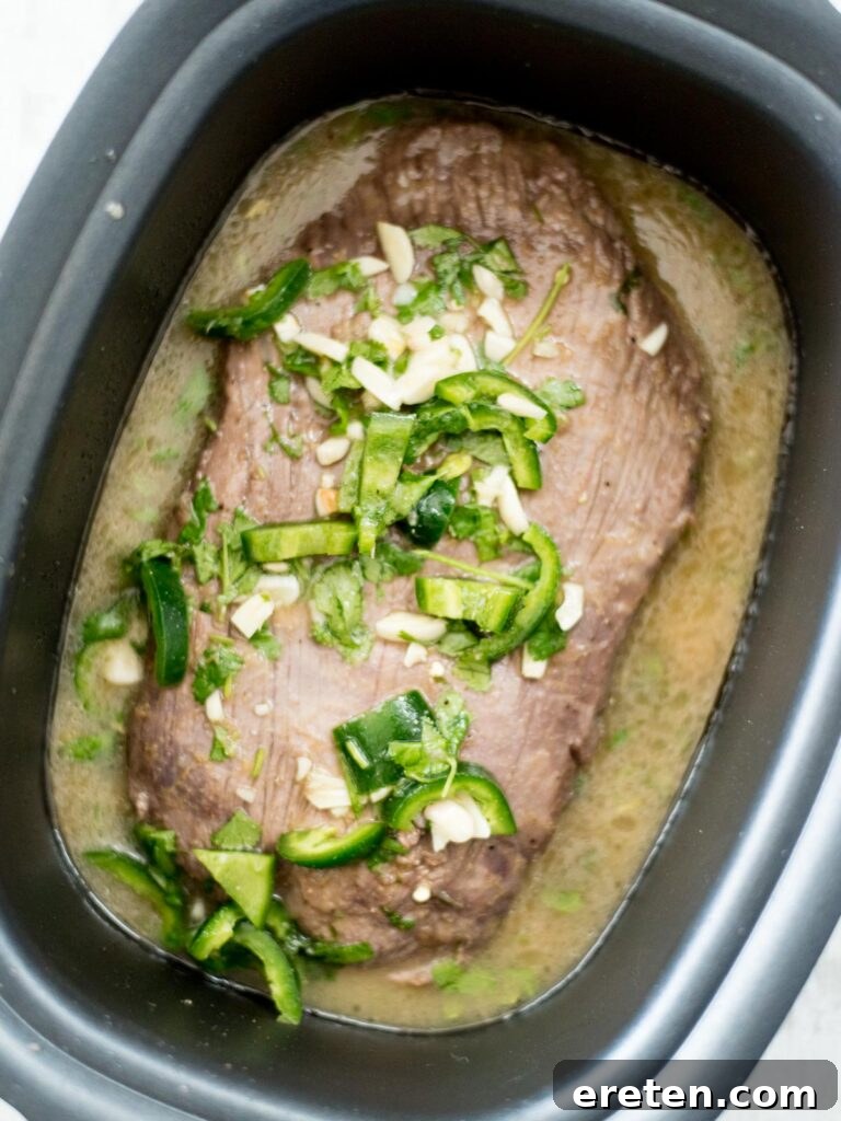 cooked flank steak in slow cooker