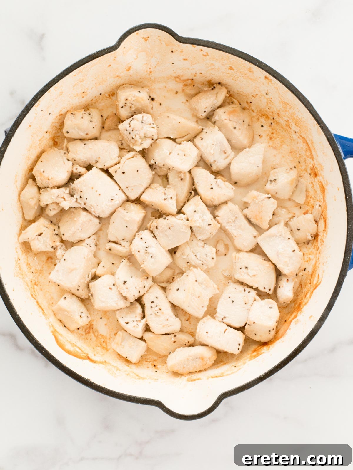 chicken searing in a skillet