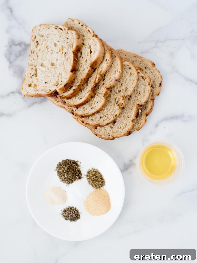 Ingredients for homemade croutons in the air fryer, including bread, oil, and various spices